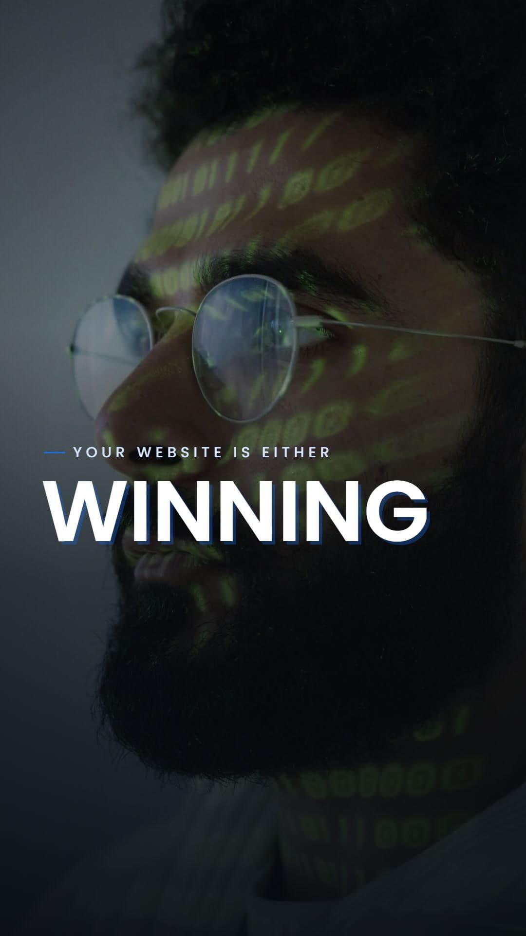 A man in glasses lit by green code under the line your website is either WINNING