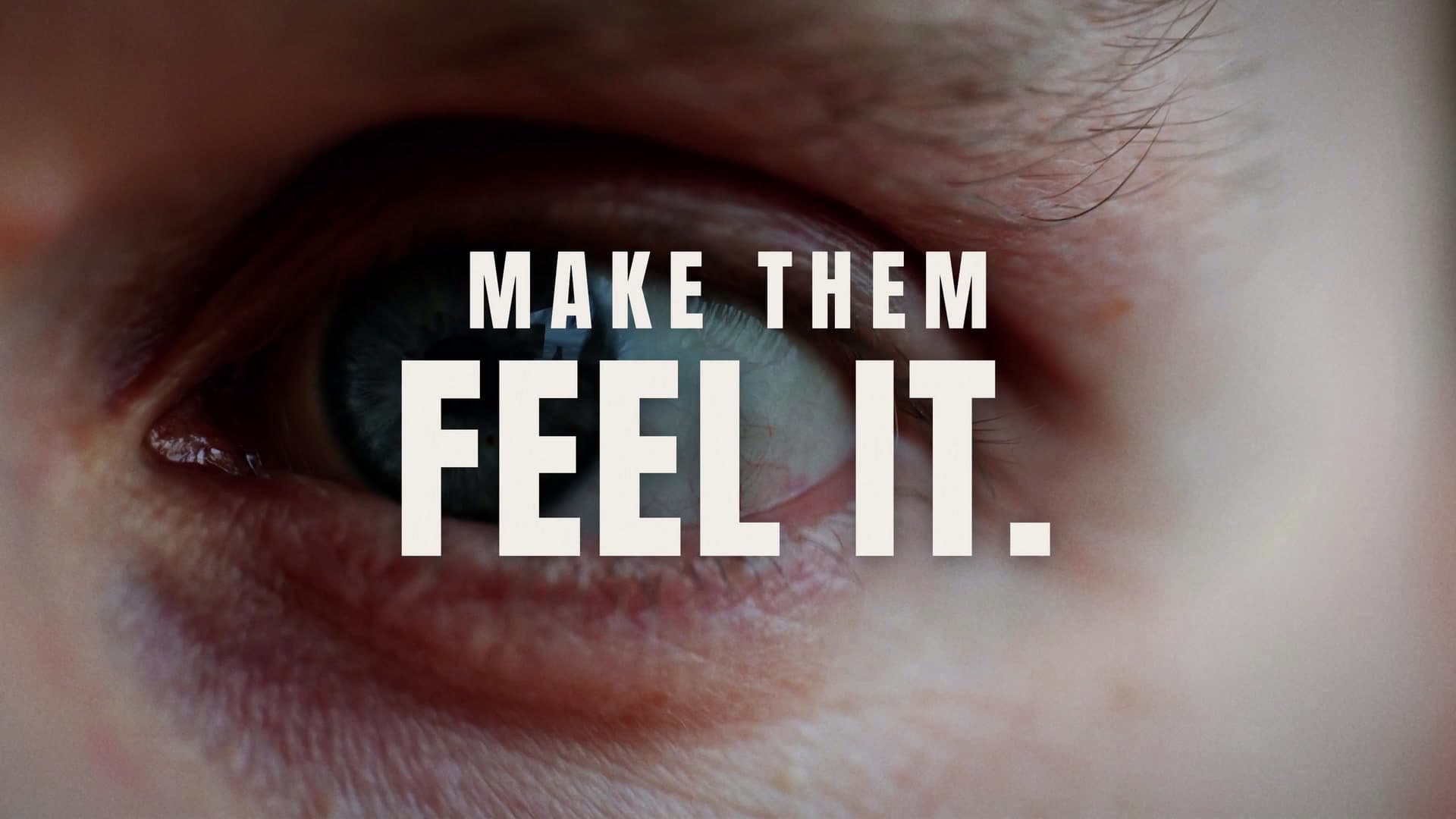 Extreme close-up of an eye under the title MAKE THEM FEEL IT, from The Power of One Frame cinematic short