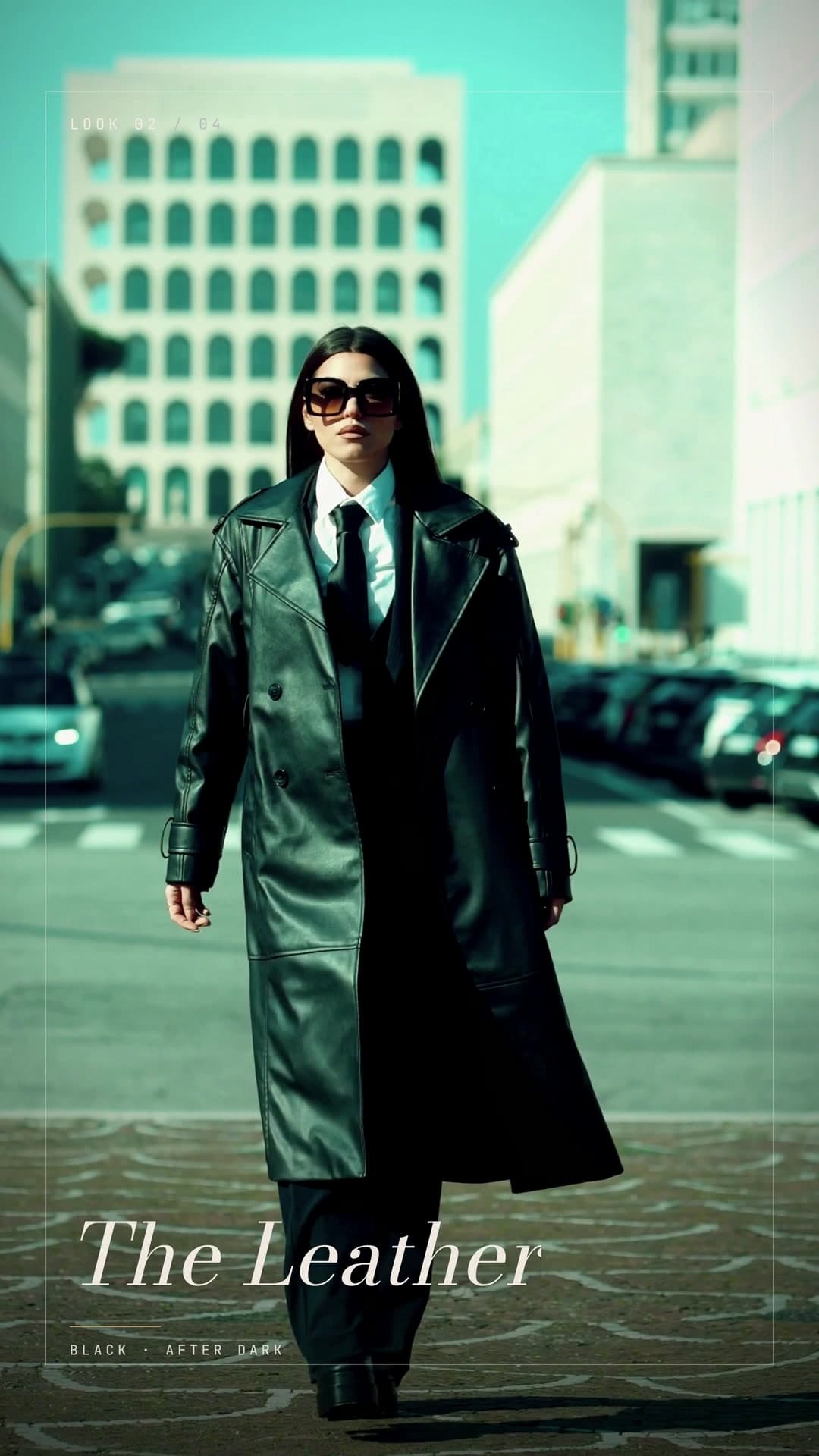 A woman in a long leather coat walking across a city square, titled The Leather